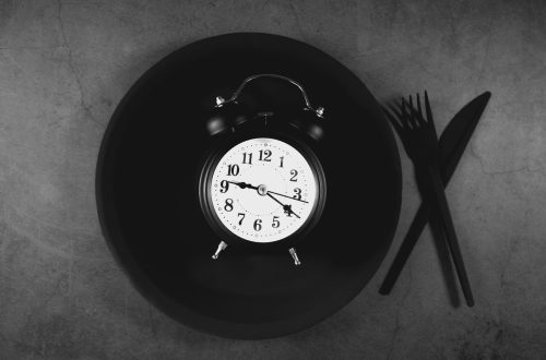 Alarm clock on a plate with cutlery