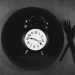 Alarm clock on a plate with cutlery
